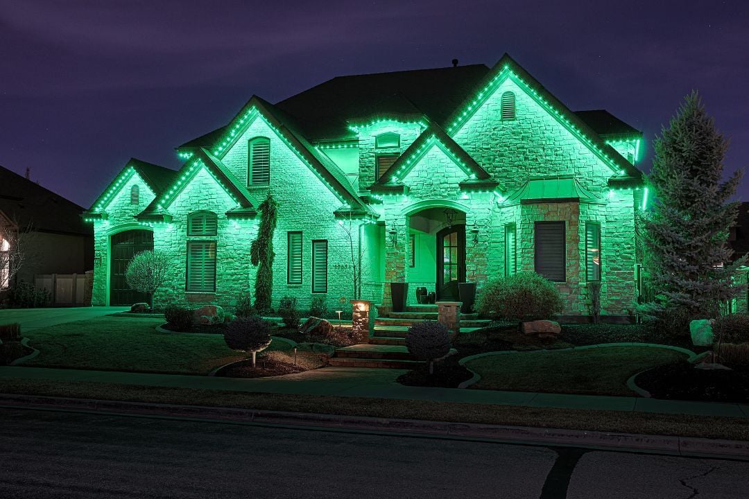 A home that has a full green Trimlight pattern to celebrate Saint Patrick's Day.