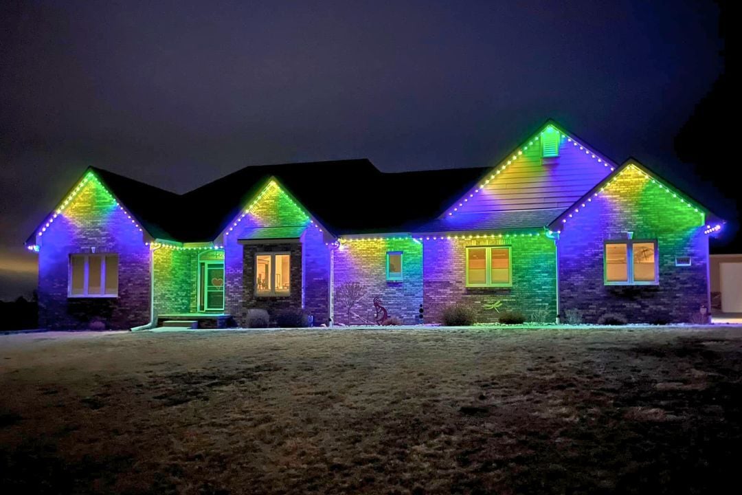 A home that has vibrant Mardi Gras Trimlight patterns on their home.