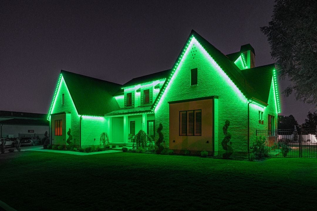 A modern home with two peaks with a Trimlight Saint Patrick's day pattern.