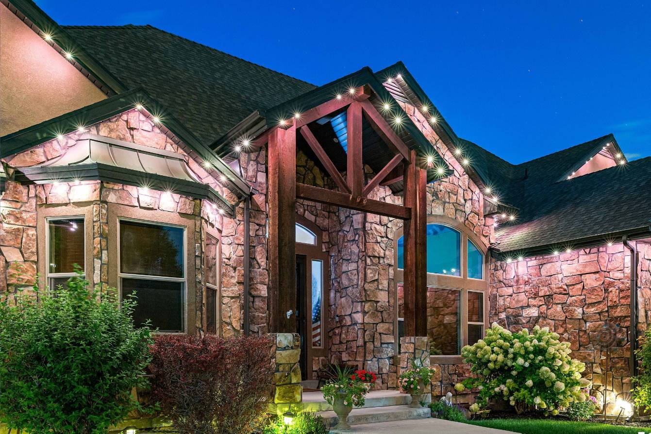 a home with bushes and landscape lighting, followed with bright LEDs on the home representing accent lighting