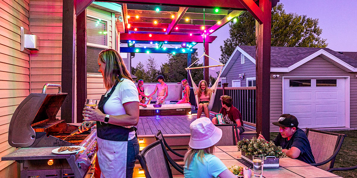 colorful programmable string lights on back patio over hot tub