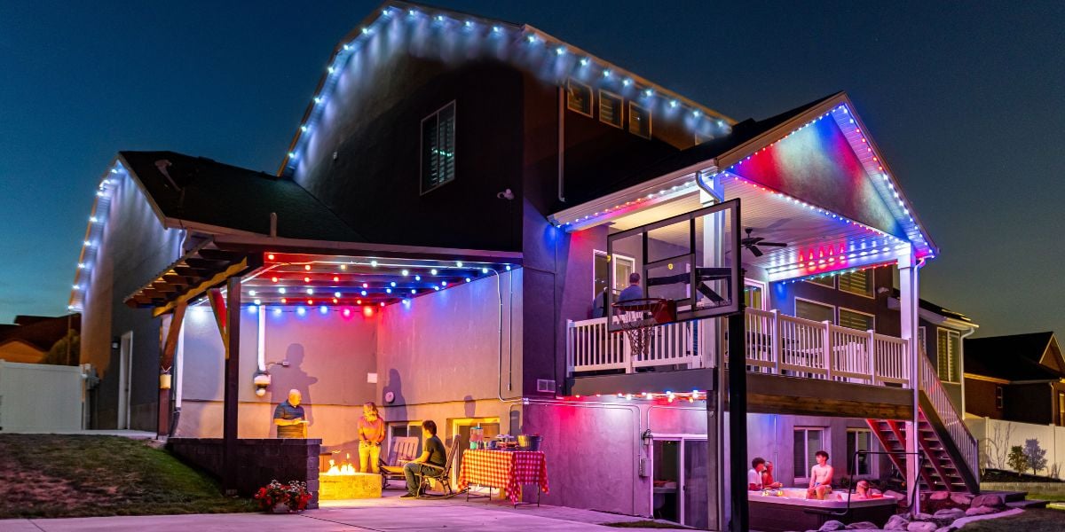 Outdoor holiday lights showing on a home during nice weather