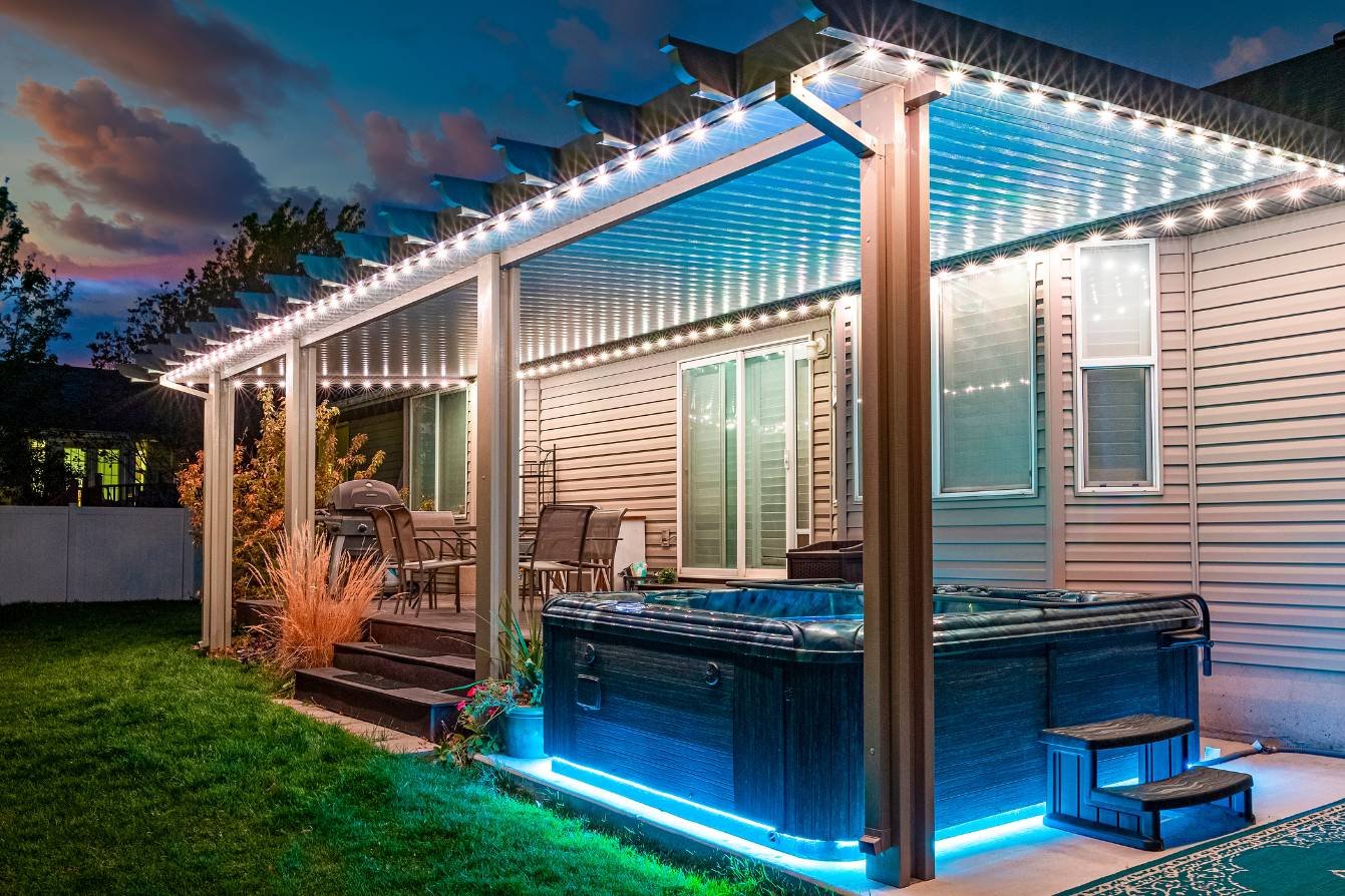 well lit up accent lighting patio with a hot tub that has blue LED lighting under.
