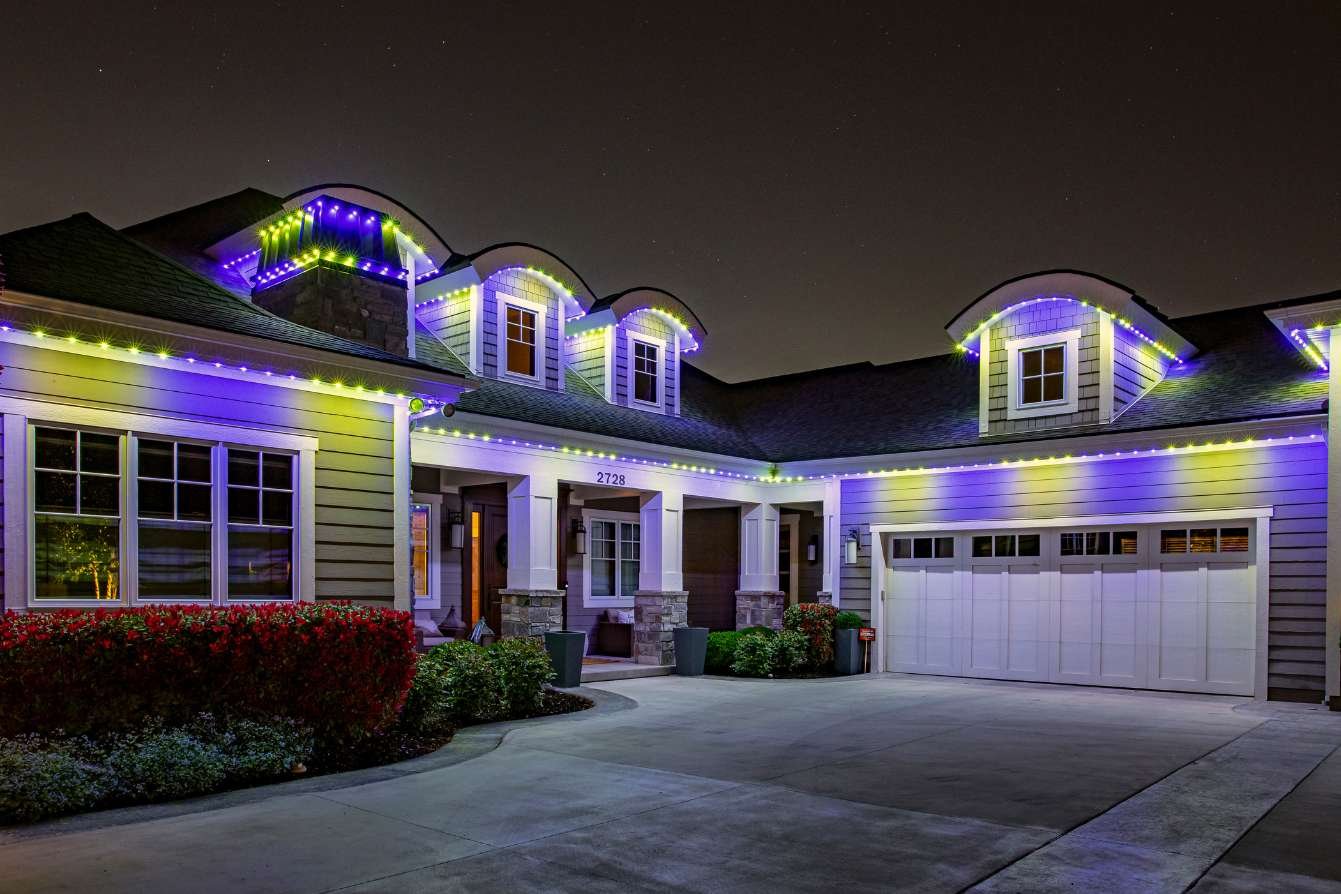 purple and yellow LEDs on a home with rounded peaks