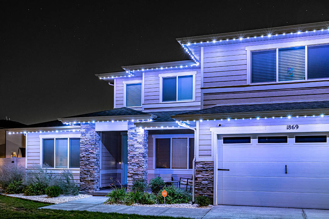 White permanent lighting on a home with a blue glow