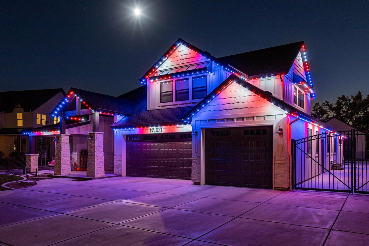 red white blue accent lighting on modern house and side yard